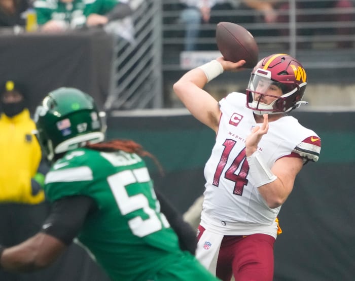 Dec 24, 2023; East Rutherford, New Jersey, USA; Washington Commanders quarterback Sam Howell (14) throws against the New York Jets in the first quarter at MetLife Stadium.